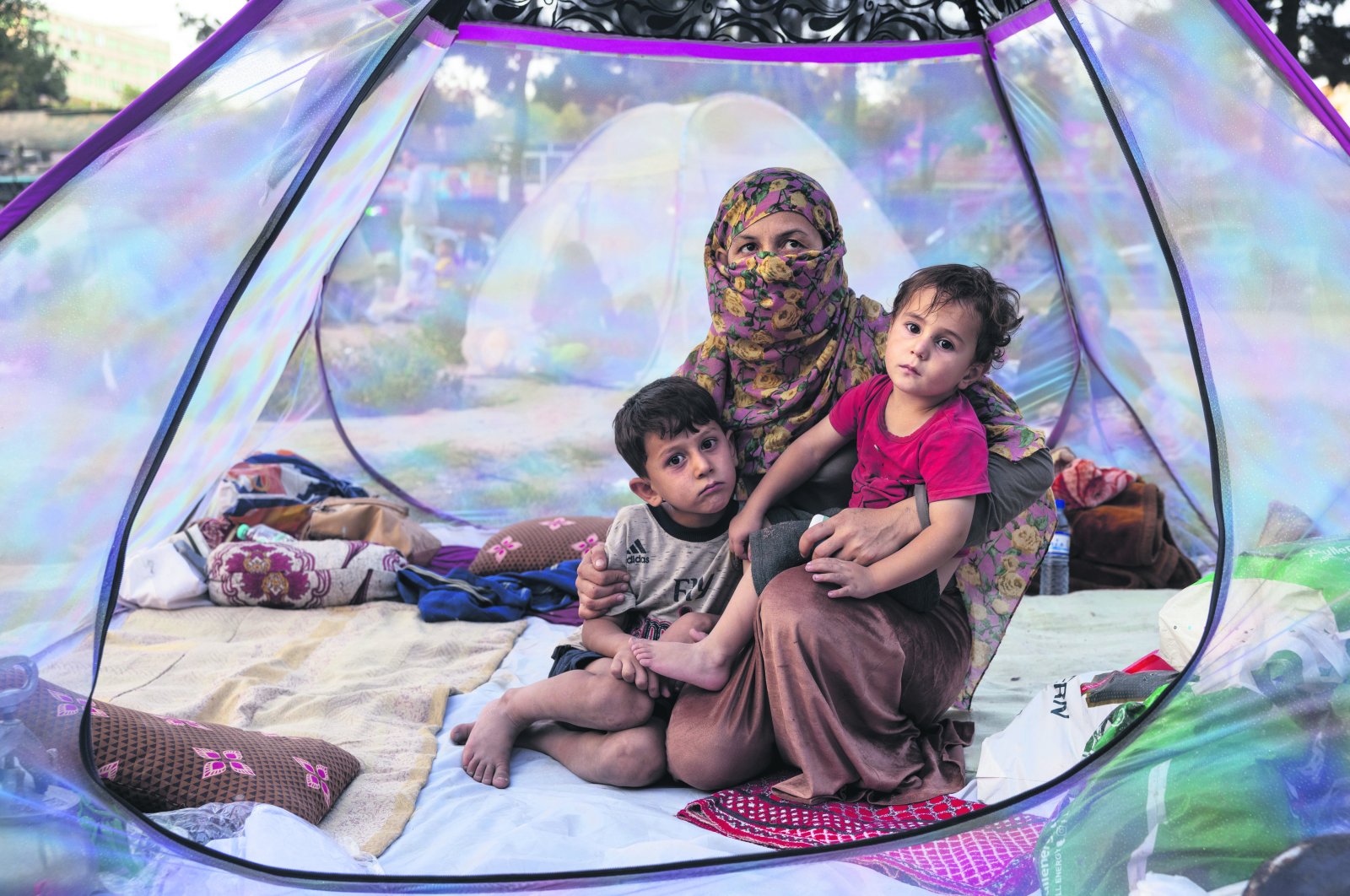 An Afghan family sits in a tent at a makeshift camp for displaced people in Kabul, Afghanistan, Aug. 12, 2021. (Photo by Getty Images)