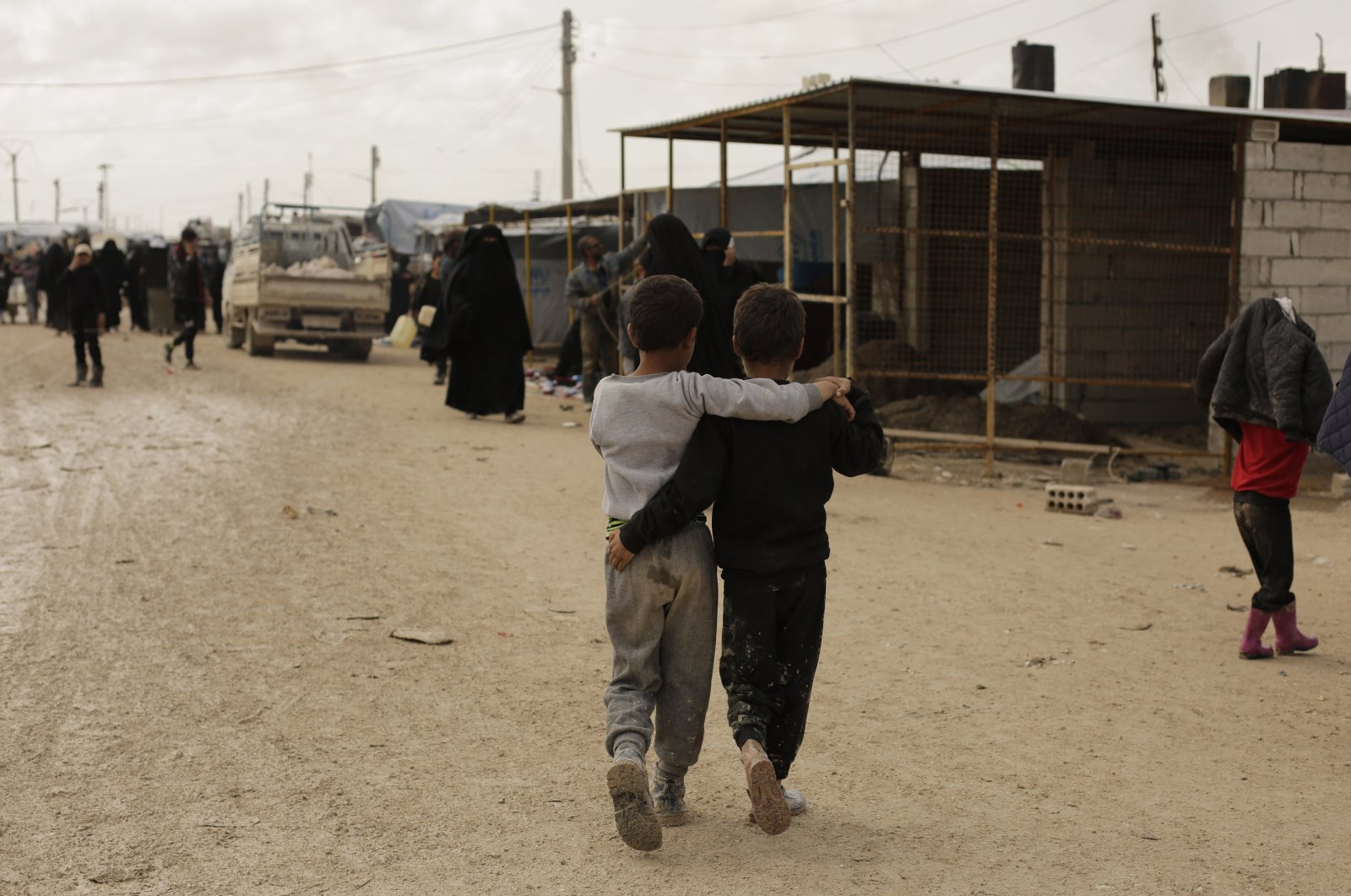 Boys walk together in the marketplace at Al-Hol camp, Hassakeh province, Syria, March 31, 2019. (AP File Photo)