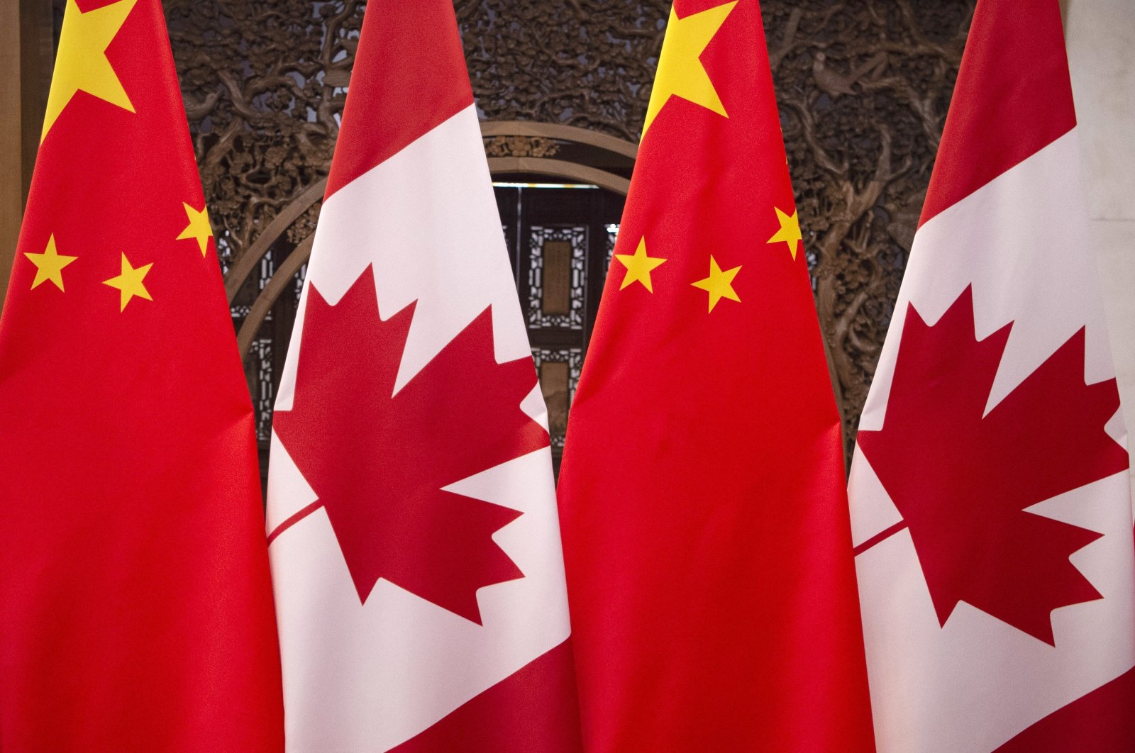 Flags of Canada and China prior to a meeting of Canadian Prime Minister Justin Trudeau and Chinese President Xi Jinping at the Diaoyutai State Guesthouse in Beijing, Dec. 5, 2017. (AP File Photo)