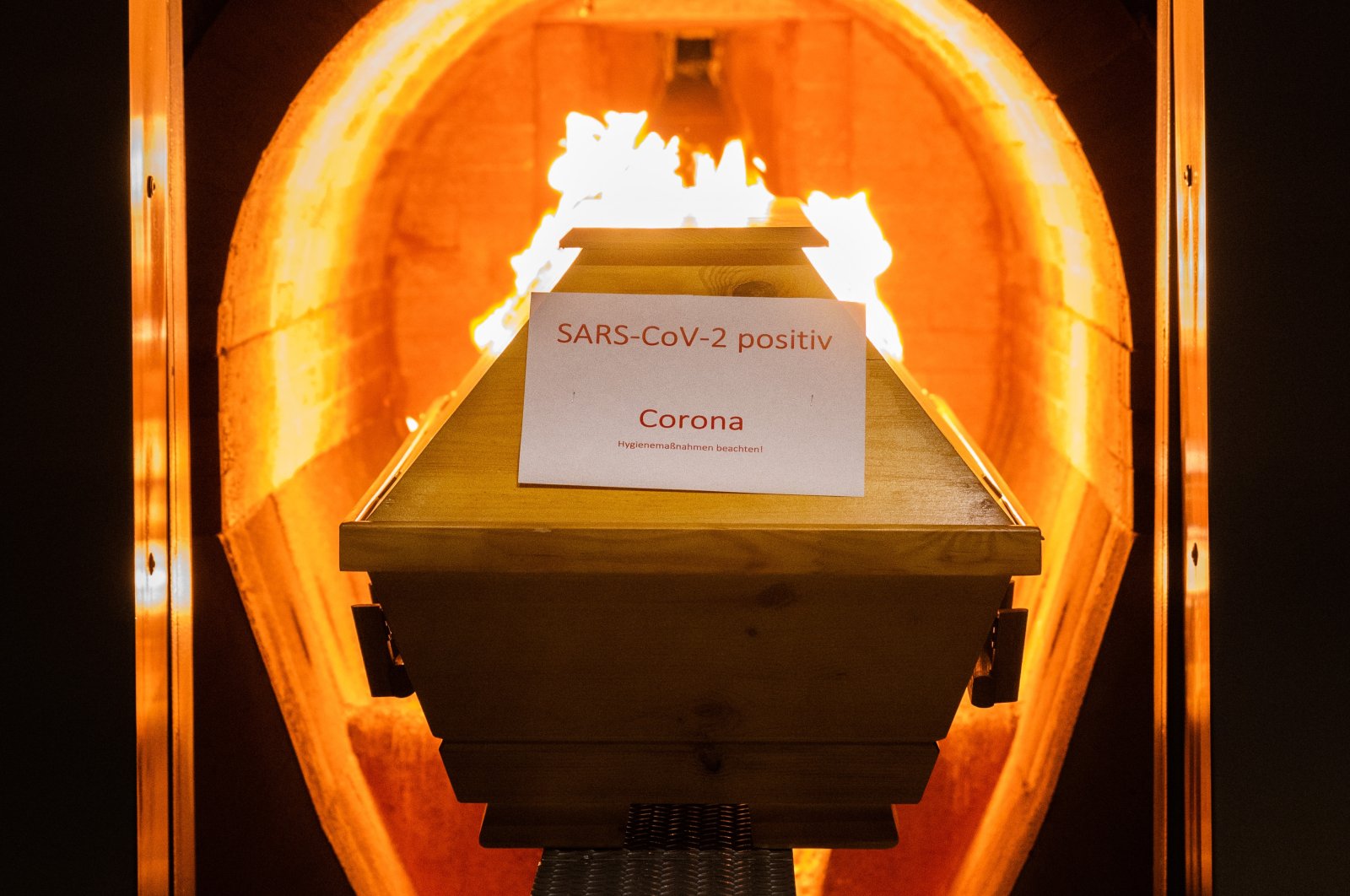 A deceased person in a coffin labelled “SARS-CoV-2 positive – Corona” is cremated in an oven at the crematorium “Die Feuerbestattungen Hildesheim,” in Giesen, Lower Saxony, Germany, Nov. 25, 2021. (Getty Images)