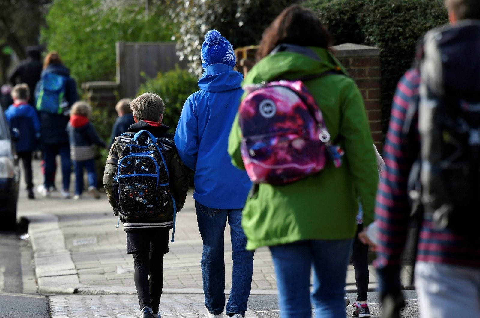 Parents walk their children to school on the last day before their official closure, as the spread of the coronavirus disease (COVID-19) continues, in West London, Britain, March 20, 2020. (Reuters File Photo)