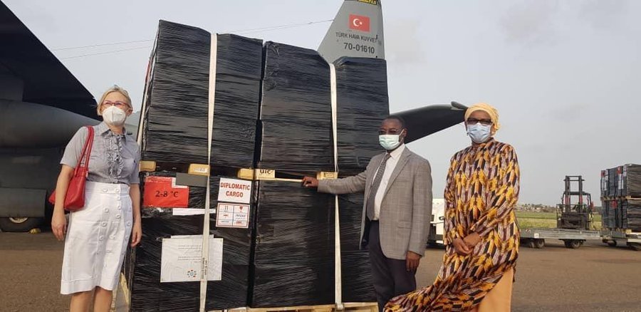 Turkish Ambassador to Lome Esra Demir (L) poses next to the vaccine cargo with Togolese Health Minister Moustafa Mijiyawa at the airport in Lome, Togo, Dec. 6, 2021. (AA PHOTO)