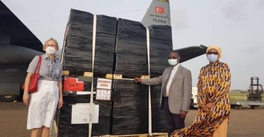 Turkish Ambassador to Lome Esra Demir (L) poses next to the vaccine cargo with Togolese Health Minister Moustafa Mijiyawa at the airport in Lome, Togo, Dec. 6, 2021. (AA PHOTO)