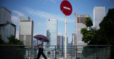A man walks past a No Entry traffic sign near the headquarters of China Evergrande Group in Shenzhen, Guangdong province, China, Sept. 26, 2021. (Reuters Photo)