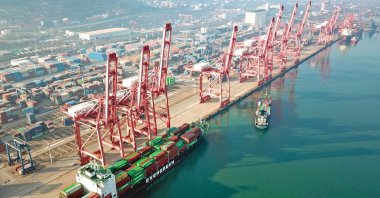 Gantry cranes for loading containers onto cargo ships line the dock of a port in Lianyungang, in eastern Jiangsu province, China, Dec. 7, 2021. (AFP Photo)