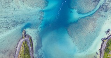 An aerial view of turquoise waters of a lagoon surrounding the Maconde Viewpoint along the coastal road, aerial view at Bel Ombre, Baie Du Cap, Indian Ocean. (Getty Images)