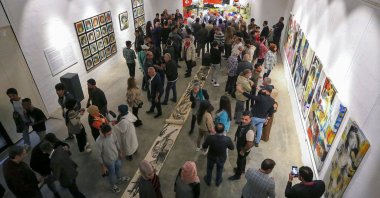 Visitors attend the opening of an exhibition by plastic artist Riyad Ghania in the capital Baghdad, Iraq, Nov. 26, 2021. (AFP Photo)