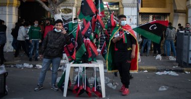 Men sell flags during a gathering to commemorate the tenth anniversary of the Arab Spring in Martyrs Square, Tripoli, Libya, Feb. 17, 2021. (Photo by Getty Images)