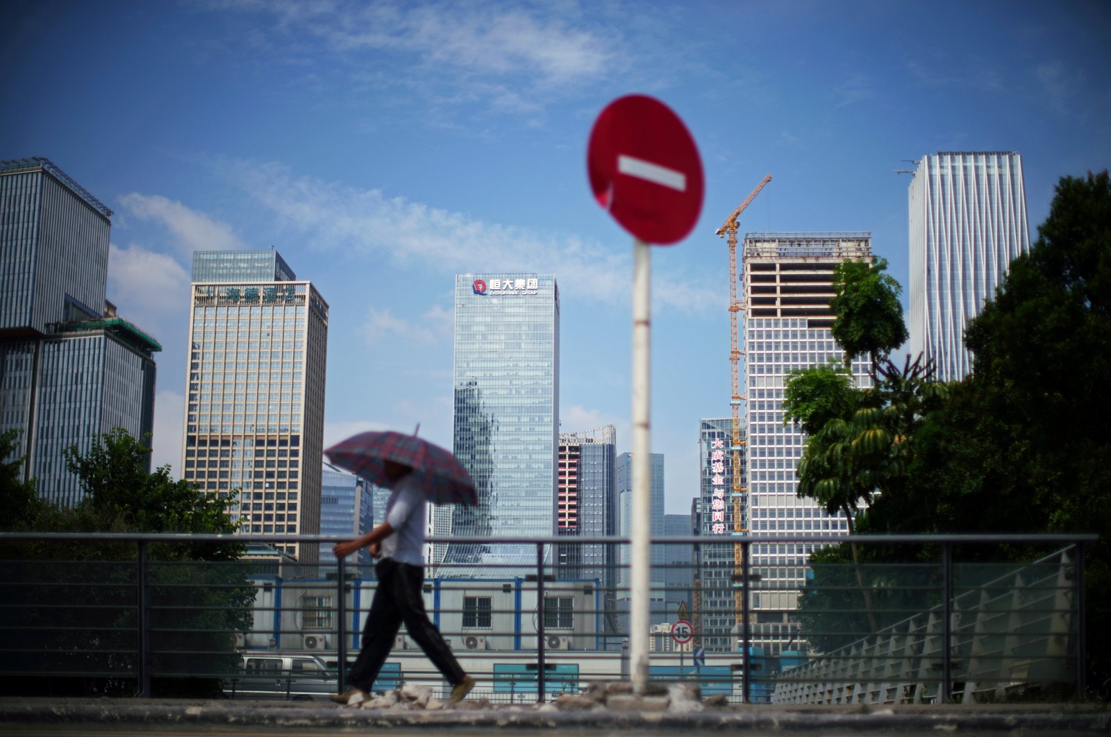 A man walks past a No Entry traffic sign near the headquarters of China Evergrande Group in Shenzhen, Guangdong province, China, Sept. 26, 2021. (Reuters Photo)