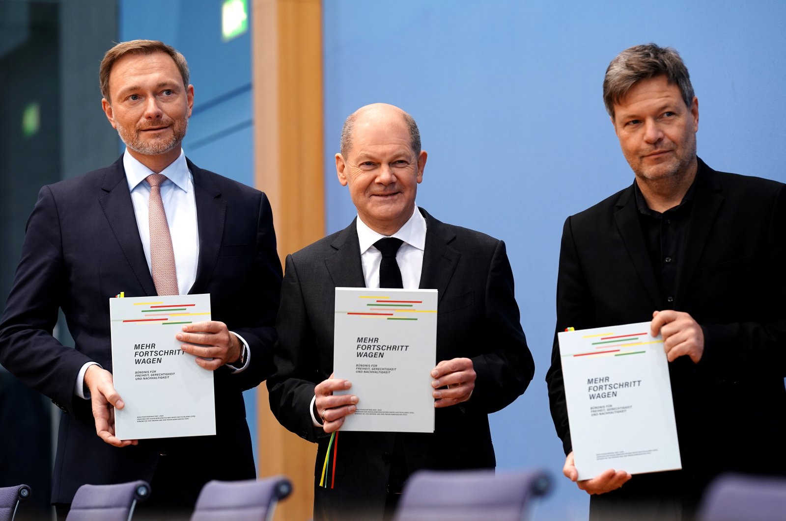 Designated Chancellor Olaf Scholz (C), designated German Minister of Finance Christian Lindner (L) and designated Minister for Economic Affairs and Climate Protection Robert Habeck (R) pose after signing the coalition agreement of Social Democratic Party (SPD), Green party (Die Gruenen) and Free Democratic Party (FDP) in Berlin, Germany, Dec. 7, 2021. (EPA Photo)