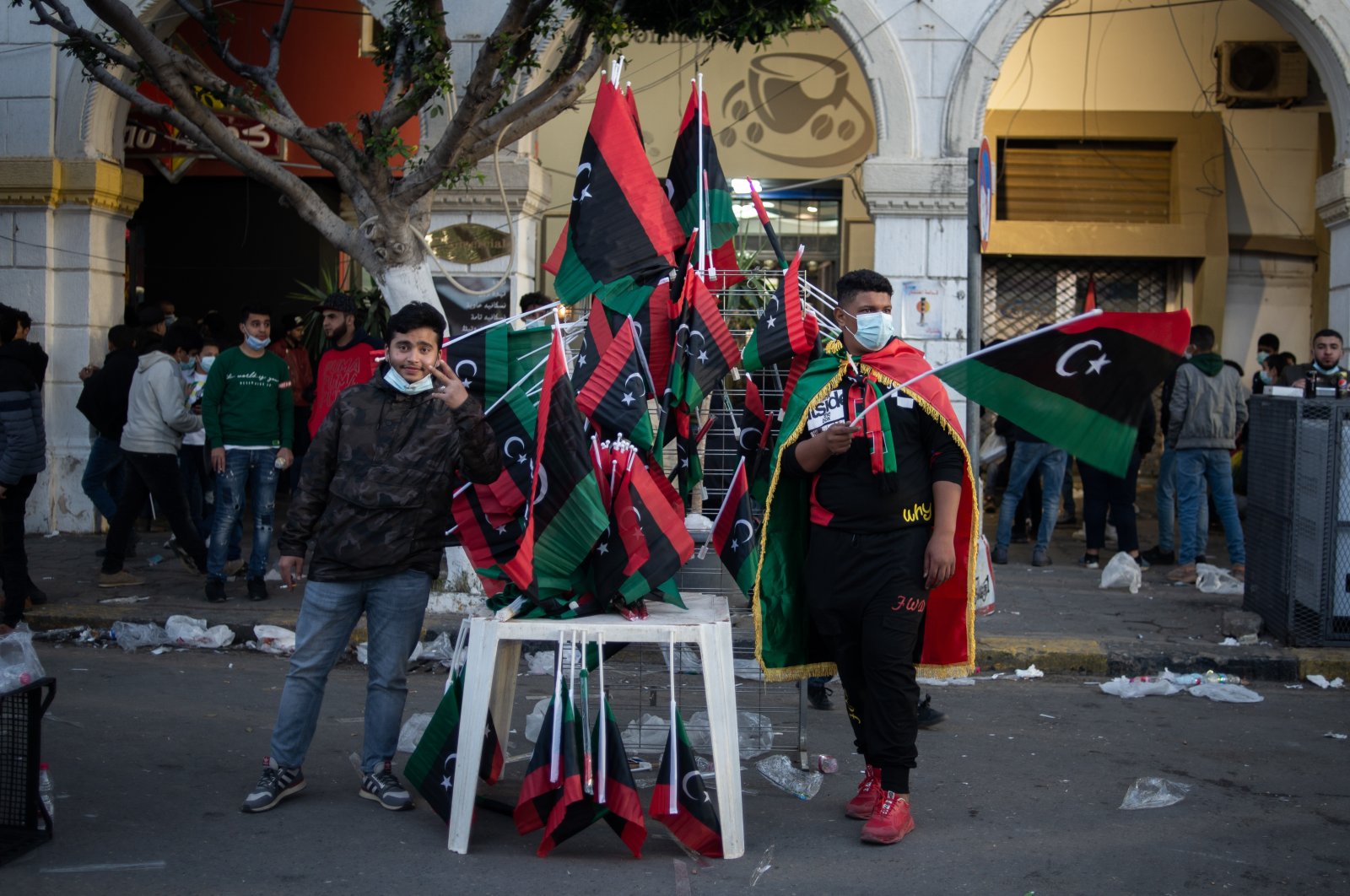 Men sell flags during a gathering to commemorate the tenth anniversary of the Arab Spring in Martyrs Square, Tripoli, Libya, Feb. 17, 2021. (Photo by Getty Images)