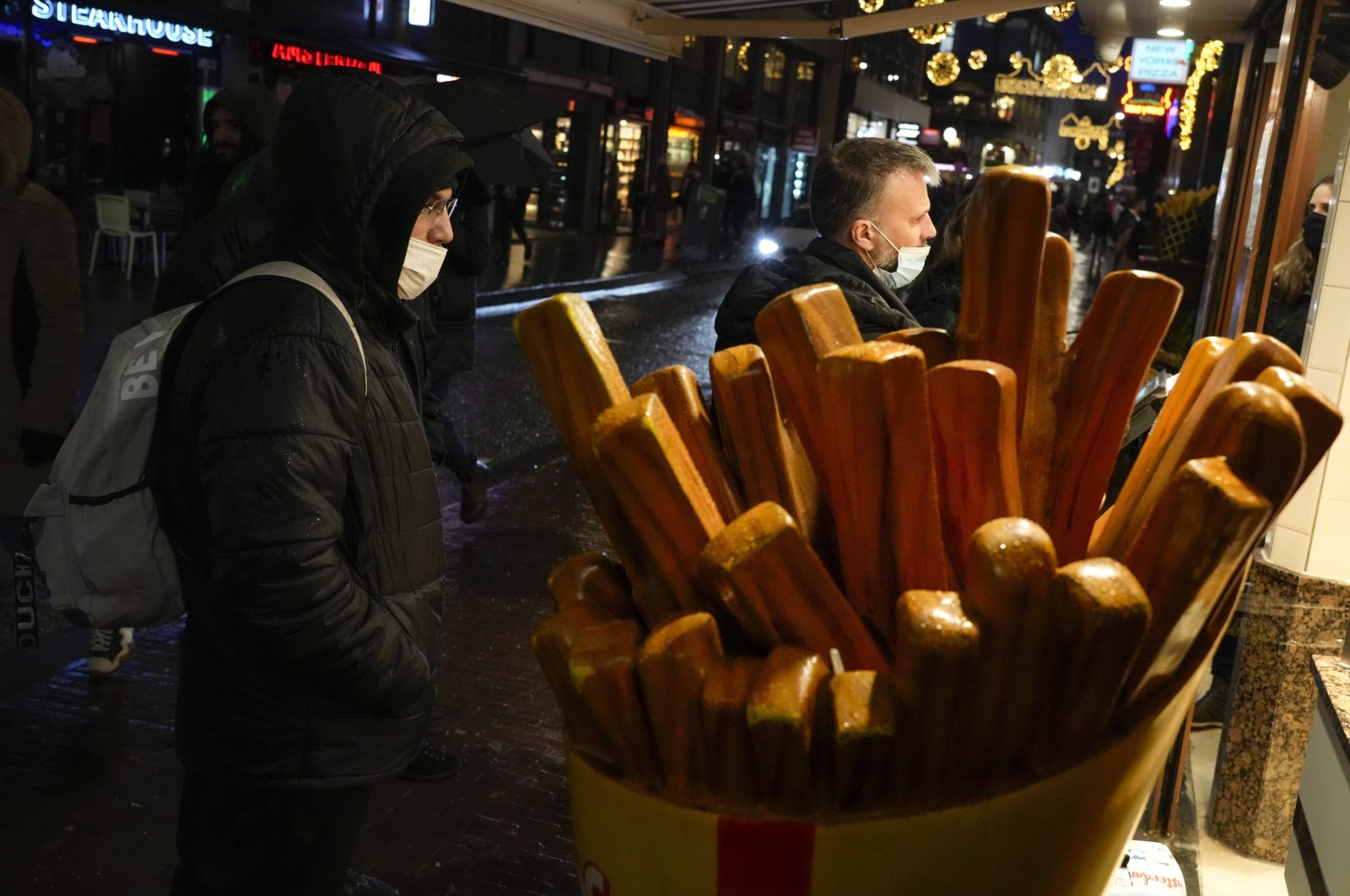 In this file photo, people can be seen queuing to order take-out french fries, Nov. 29, 2021. (AP Photo)