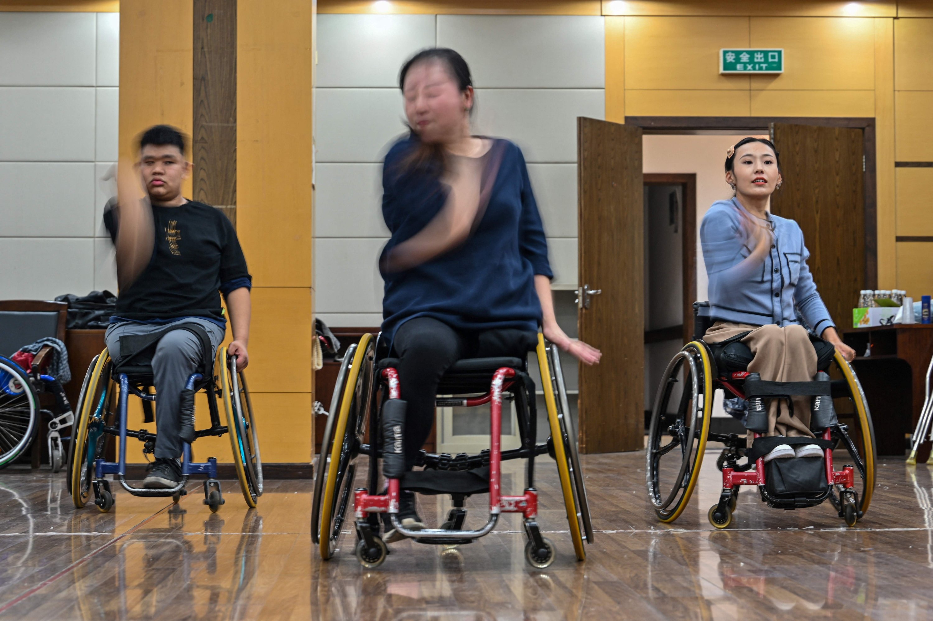 This photo shows wheelchair dancers practicing with the Shanghai Oriental Pearl TV Tower Handicapped Art Troupe on the outskirts of Shanghai, China, Oct. 21, 2021.  (AFP Photo)
