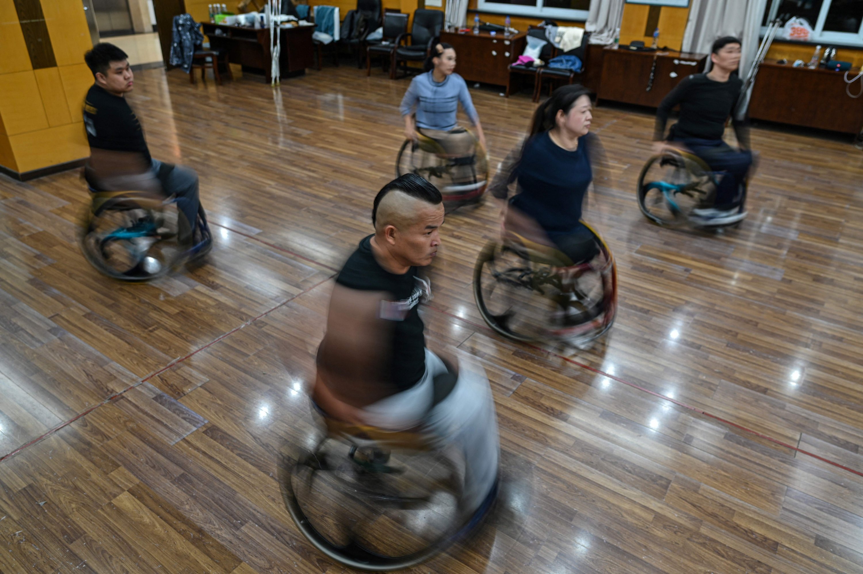 This photo shows wheelchair dancers practicing with the Shanghai Oriental Pearl TV Tower Handicapped Art Troupe on the outskirts of Shanghai, China, Oct. 21, 2021. (AFP Photo)