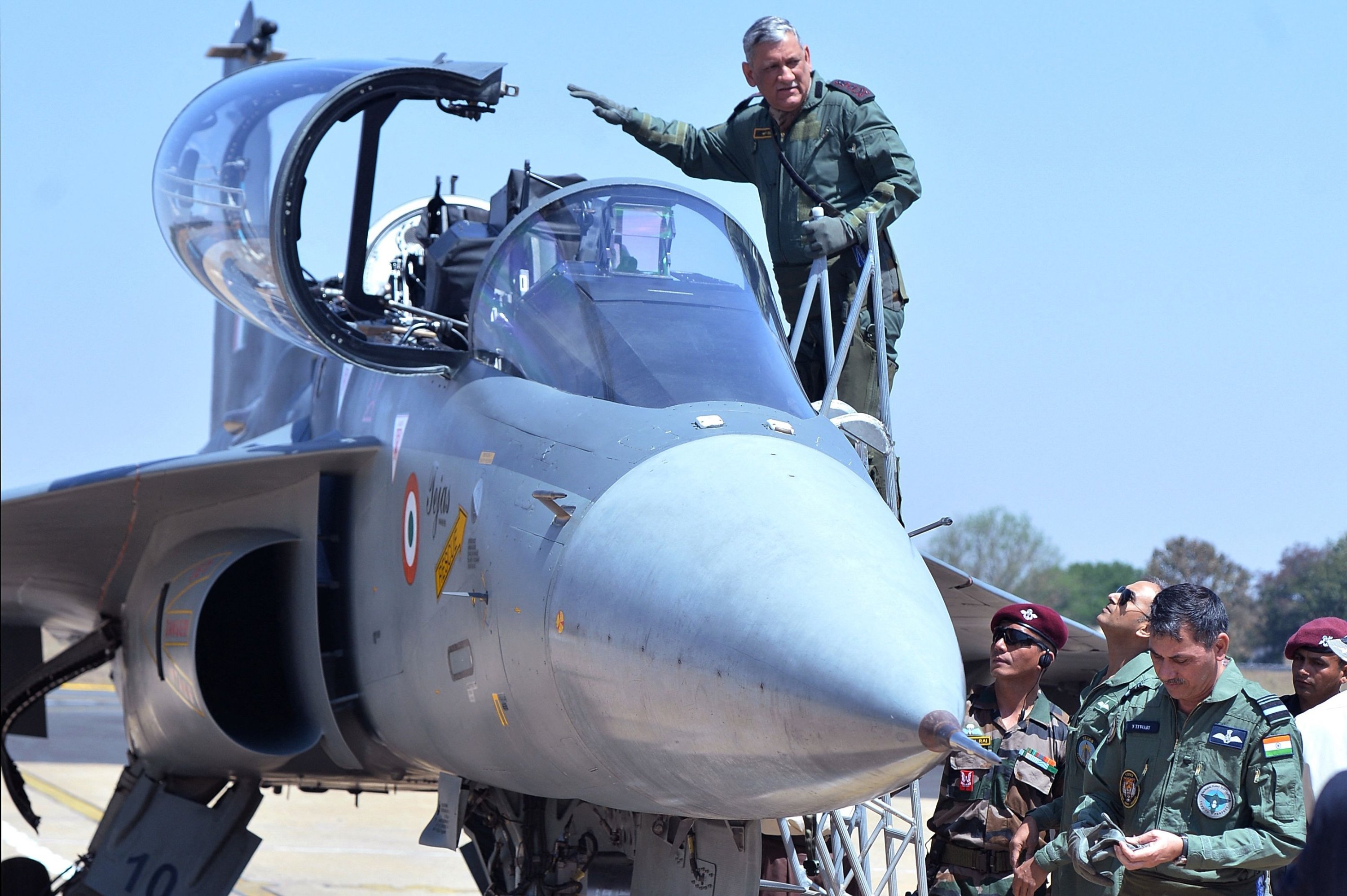 In this file photo, the then-27th chief of army staff, Bipin Rawat, waves as he boards the co-pilot seat of a Light Combat Aircraft of the Indian Air Force during the Aero India airshow at the Yelahanka Air Force station in Bangalore, India, Feb. 21, 2019. (AFP Photo)