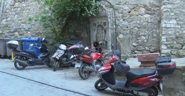 This file photo shows the historic fountain behind a protective cage and parked motorcycles in Galatasaray quarter in Istanbul, May 24, 2021. (DHA Photo)