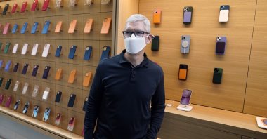 Apple CEO Tim Cook stands in front of company products during a visit to an Apple Store at The Grove, in Los Angeles, U.S., Nov. 19, 2021. (AP Photo)