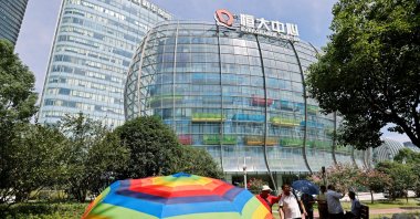 People walk outside the Evergrande Center of China Evergrande Group in Shanghai, China, Sept. 24, 2021. (Reuters Photo)