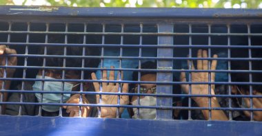 The students accused of murder try to speak to the media as they are escorted outside the court during the verdict day for the murder of student Abrar Fahad at the Speedy Trial Tribunal-1 in court, Dhaka, Bangladesh, Dec. 8, 2021. (EPA Photo)