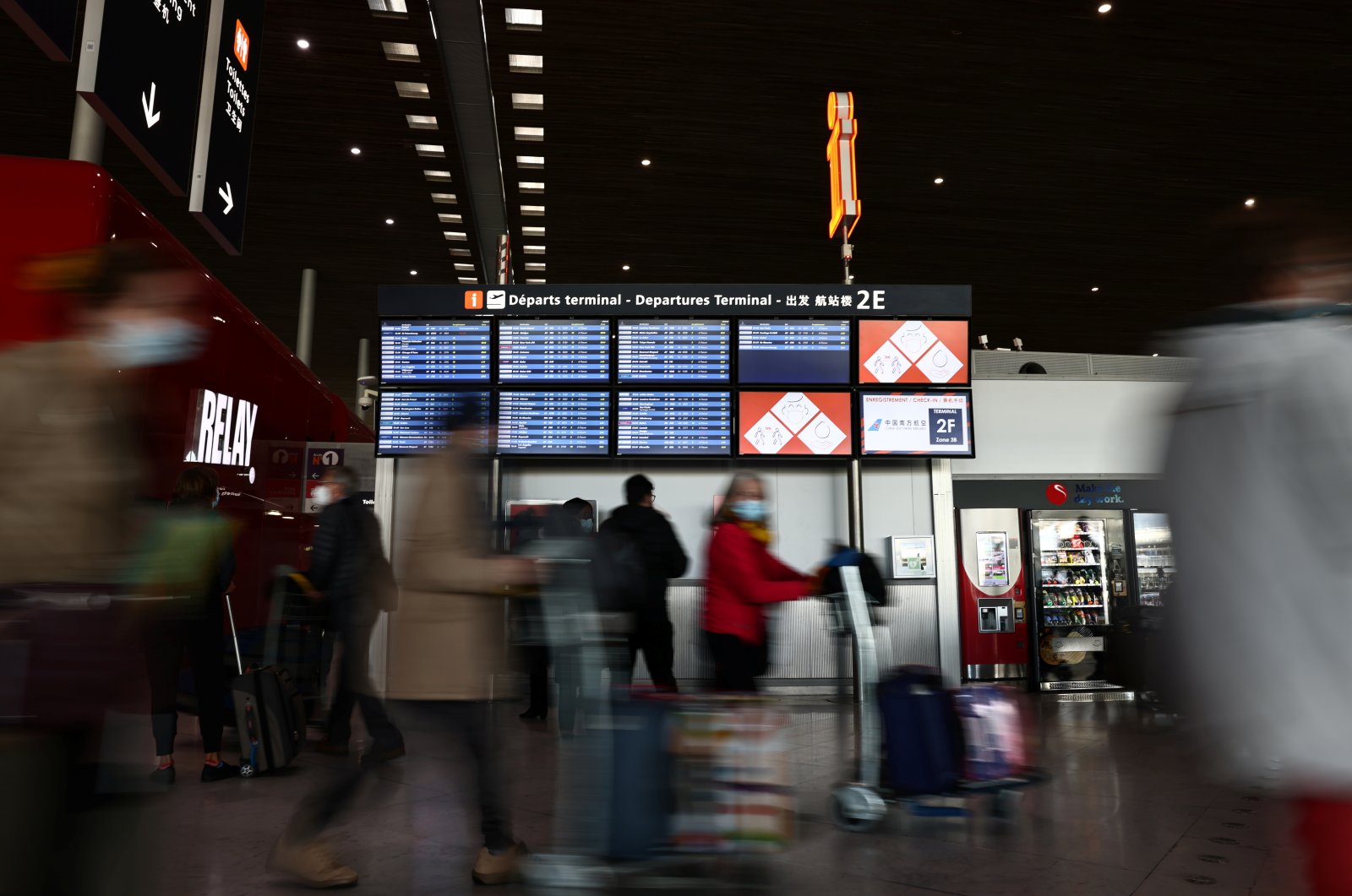Passengers walk in the departures area of the Terminal 2 at Paris Charles de Gaulle airport in Roissy-en-France near Paris, France, Dec. 2, 2021. (Reuters File Photo)