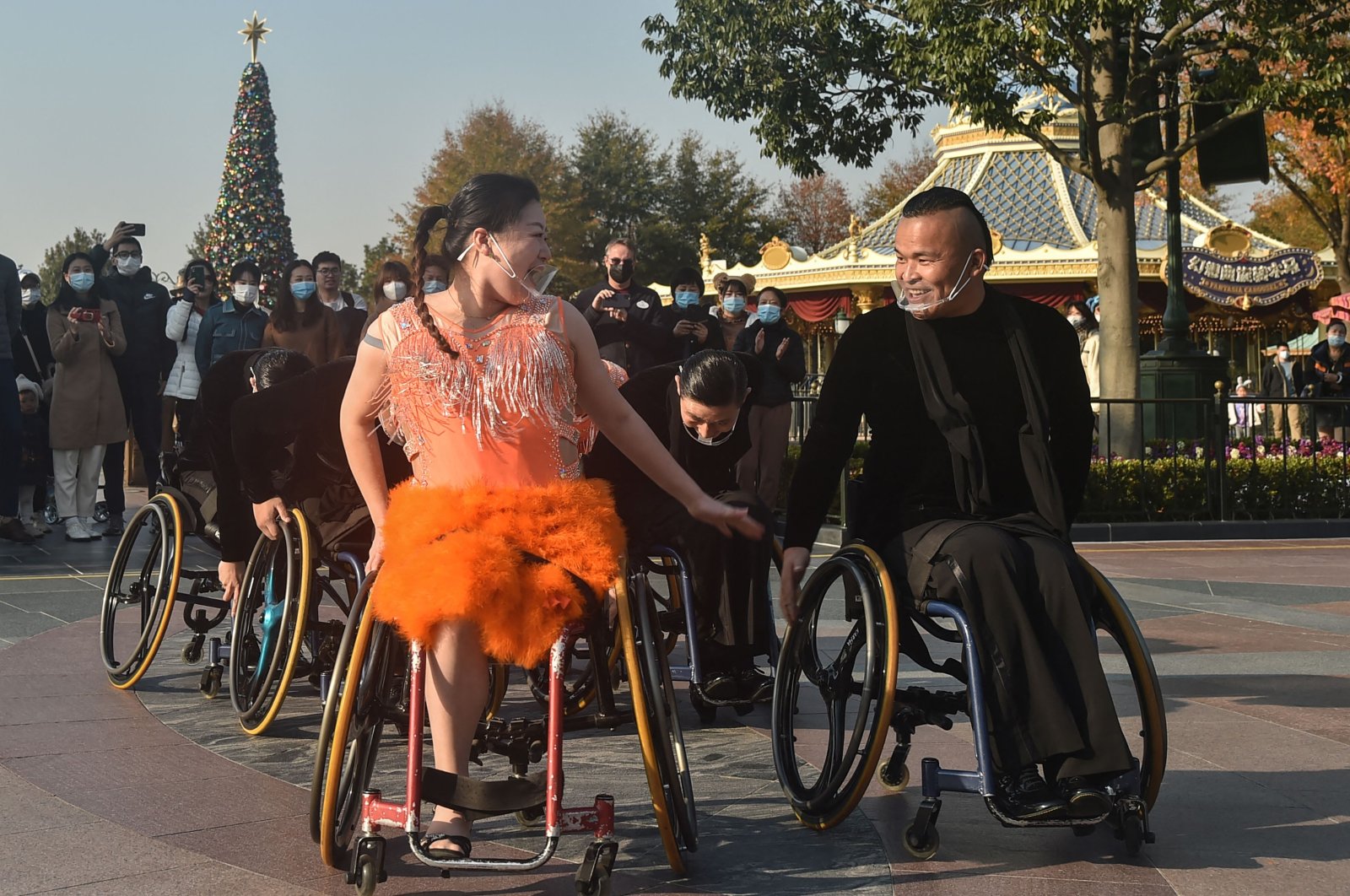 Wheelchair dancers from the Shanghai Oriental Pearl TV Tower Handicapped Art Troupe perform at Shanghai Disneyland on the International Day of Persons with Disabilities, China, Dec. 3, 2021. (AFP Photo)