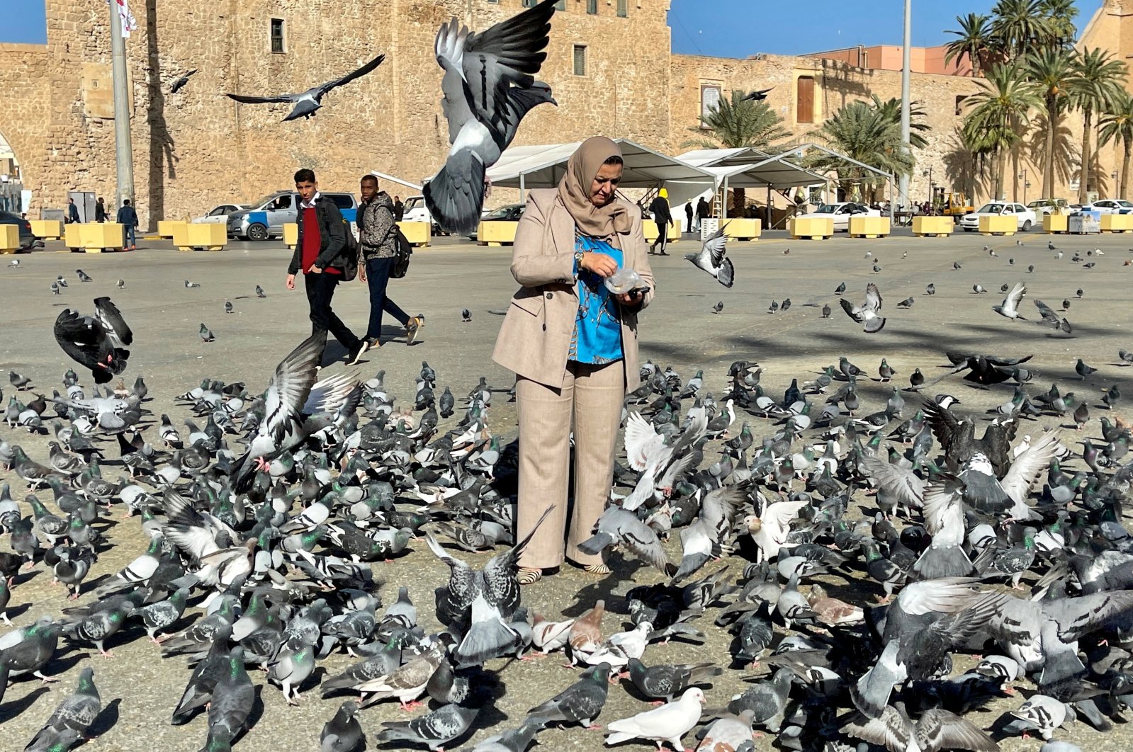 Laila bin Khalifa, one of only two women to run in Libya&#039;s first presidential election, feeds pigeons in Martyrs&#039; Square in Tripoli, Libya, Nov. 29, 2021. (Reuters Photo)