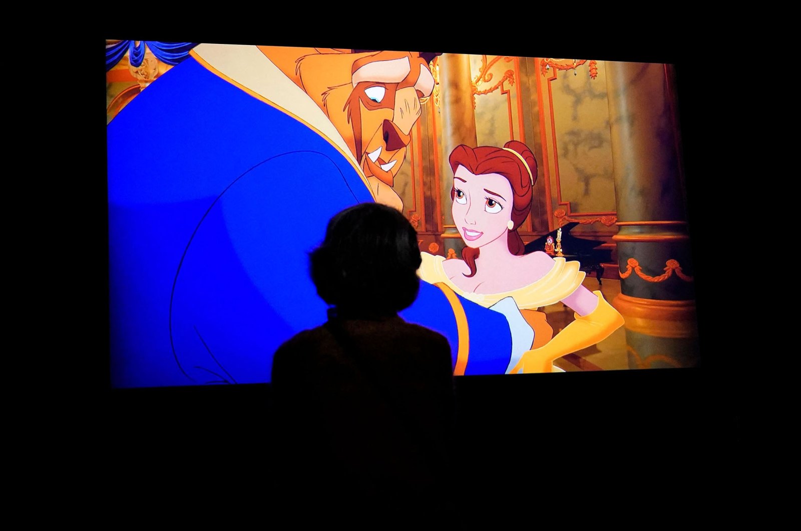 People look at a screen during a press preview for “Inspiring Walt Disney: The Animation of French Decorative Arts” at the Met in New York, U.S., Dec. 6, 2021. (AFP Photo)