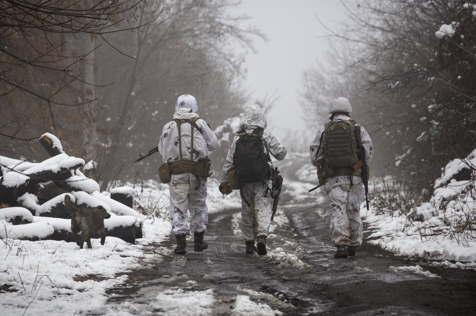 Ukrainian soldiers walk on the line of separation from pro-Russian rebels near Katerinivka, Donetsk region, Ukraine, Dec 7, 2021. (AP Photo)