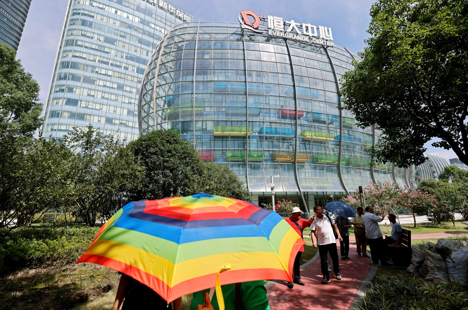 People walk outside the Evergrande Center of China Evergrande Group in Shanghai, China, Sept. 24, 2021. (Reuters Photo)