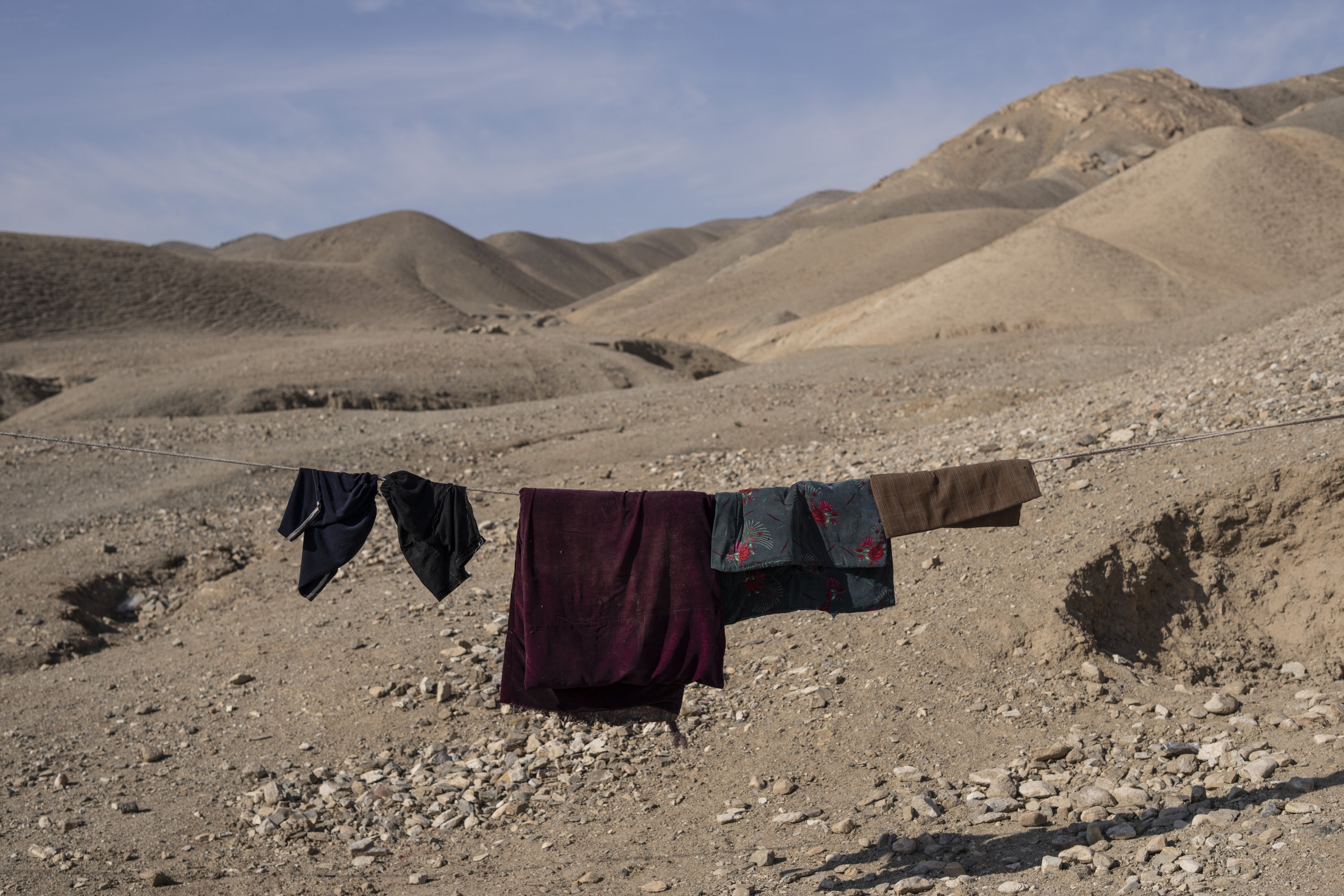 Clothes hang on a rope in Kamar Kalagh village outside Herat, Afghanistan, Nov. 26, 2021. (AP Photo)