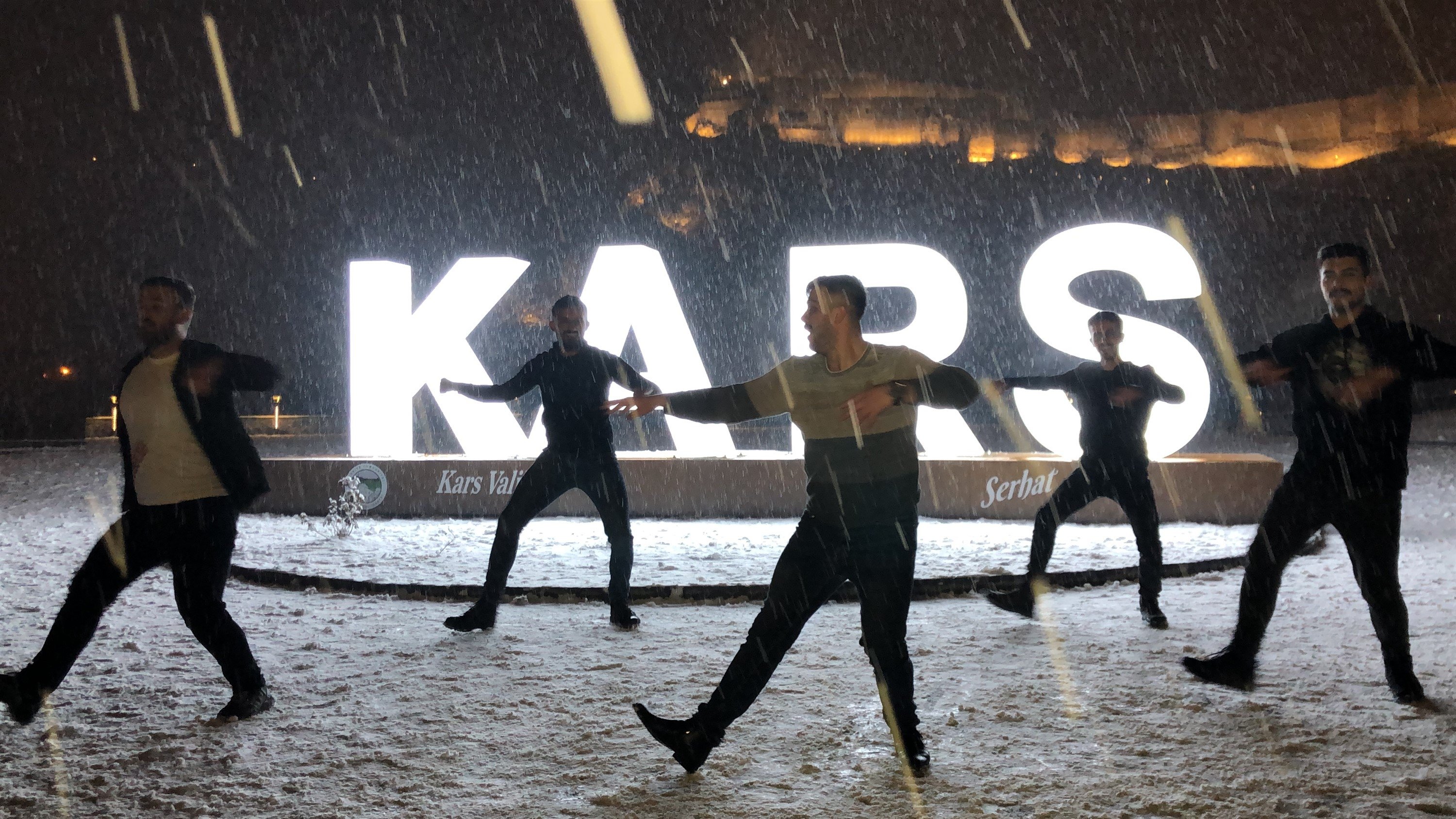Young people dance amid the snowfall, Kars, Turkey, Dec. 9, 2021. (DHA Photo)