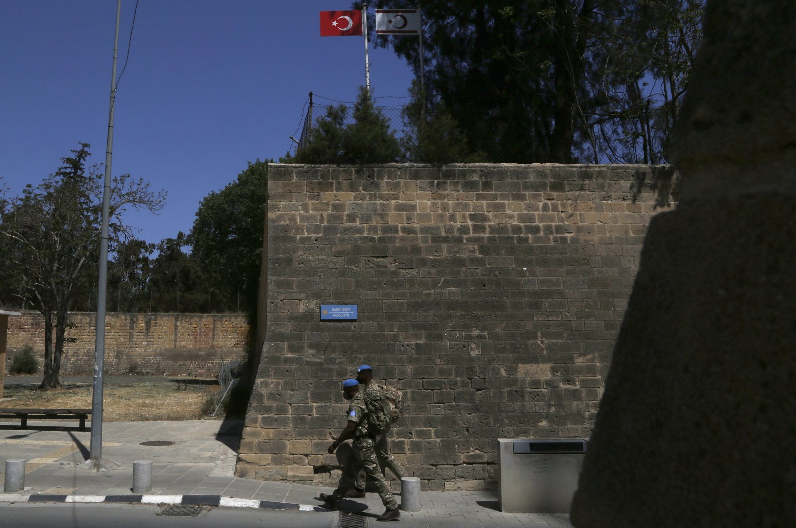 U.N peacekeepers walk by the Venice wall at the medieval core across the U.N buffer zone, in the divided capital Lefkoşa (Nicosia), Cyprus, April 26, 2021. (AP File Photo)