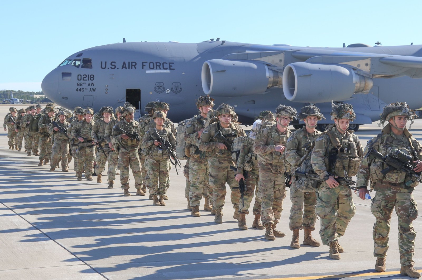 This handout picture released by the U.S. Army shows U.S. Army Paratroopers assigned to the 2nd Battalion, 504th Parachute Infantry Regiment, 1st Brigade Combat Team, 82nd Airborne Division, deploy from Pope Army Airfield, North Carolina, on Jan. 1, 2020. (U.S. Army / AFP)