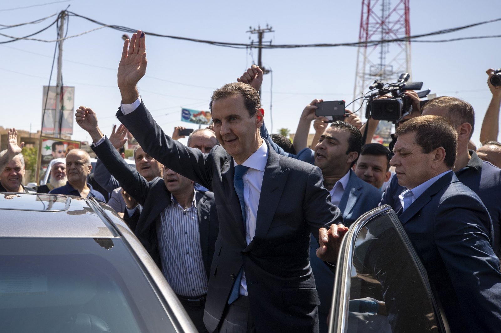 Syria&#039;s Bashar Assad (R) waves to his supporters at a polling station during the presidential elections in the town of Douma, in the eastern Ghouta region, near the Syrian capital Damascus, Syria, Wednesday, May 26, 2021.   (AP Photo)