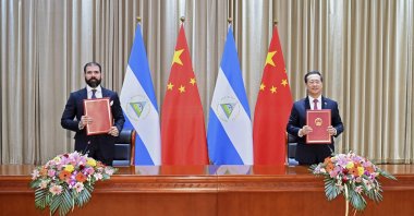 In this photo released by China’s Xinhua News Agency, representatives Laureano Ortega Murillo (L), son of and advisor to Nicaraguan President Daniel Ortega, and Chinese Vice Foreign Minister Ma Zhaoxu display their jointly signed communique on the resumption of diplomatic relations between the two countries in northern China’s Tianjin Municipality, Dec. 10, 2021. (AP Photo)