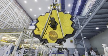 An undated handout file picture made available by NASA shows NASA technicians lifting the James Webb Space Telescope using a crane and moving it inside a clean room at NASA&#039;s Goddard Space Flight Center in Greenbelt, Maryland, U.S., issued on Dec.1, 2021. (NASA Photo via EPA)