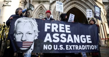 Supporters of Julian Assange display signs and a banner, outside the Royal Courts of Justice in London, Britain, Dec. 10, 2021. (Reuters Photo)