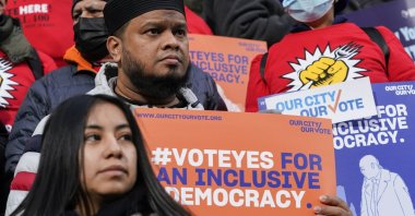 Activists participate in a rally on the steps of City Hall ahead of a City Council vote to allow lawful permanent residents to cast votes in elections to pick the mayor, City Council members and other municipal officeholders, in New York, U.S., Dec. 9, 2021. (AP Photo)