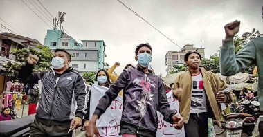 Protesters march through the streets during an anti-government demonstration in Mandalay, Myanmar, Dec. 7, 2021. (AP Photo)