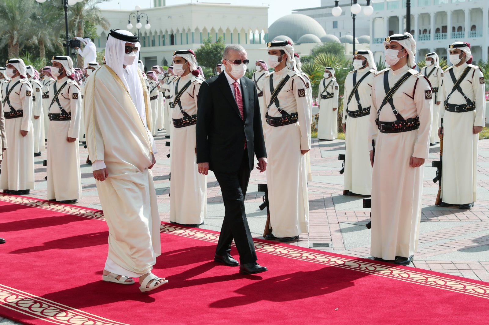 Qatar&#039;s Emir Sheikh Tamim bin Hamad Al Thani (L) and President Recep Tayyip Erdoğan (C) inspect a guard of honor during a welcome ceremony in Doha, Qatar, Dec. 7, 2021. (Reuters Photo)
