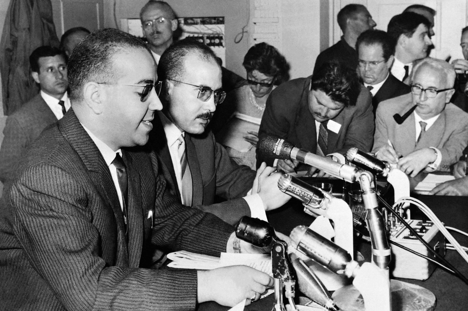 Spokesperson for the Provisional Government of the Algerian Republic (GPRA) delegation and head of the FLN press service Redha Malek (L) and Mahieddine Sadek Moussaoui (R), member of the FLN press service, deliver a press conference, in Geneva, during the negotiations to end war in Algeria, which will lead to the Evian accords, between the French Government and the Provisional Government of the Algerian Republic (GPRA), May 17, 1961. (AFP File Photo)