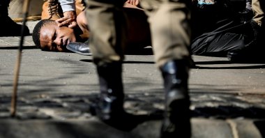 Police officers detain a person during a protest, as violence following the jailing of former South African President Jacob Zuma spread to the country&#039;s main economic hub in Johannesburg, South Africa, July 11, 2021. (Reuters Photo)