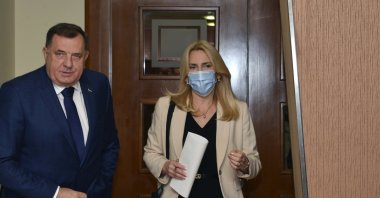 Bosnian Serb member of the tripartite Bosnian presidency Milorad Dodik (L) and President of Republika Srpska Zeljka Cvijanovic arrive at the Parliament session in Banja Luka, Bosnia, Friday, Dec. 10, 2021. (AP Photo)