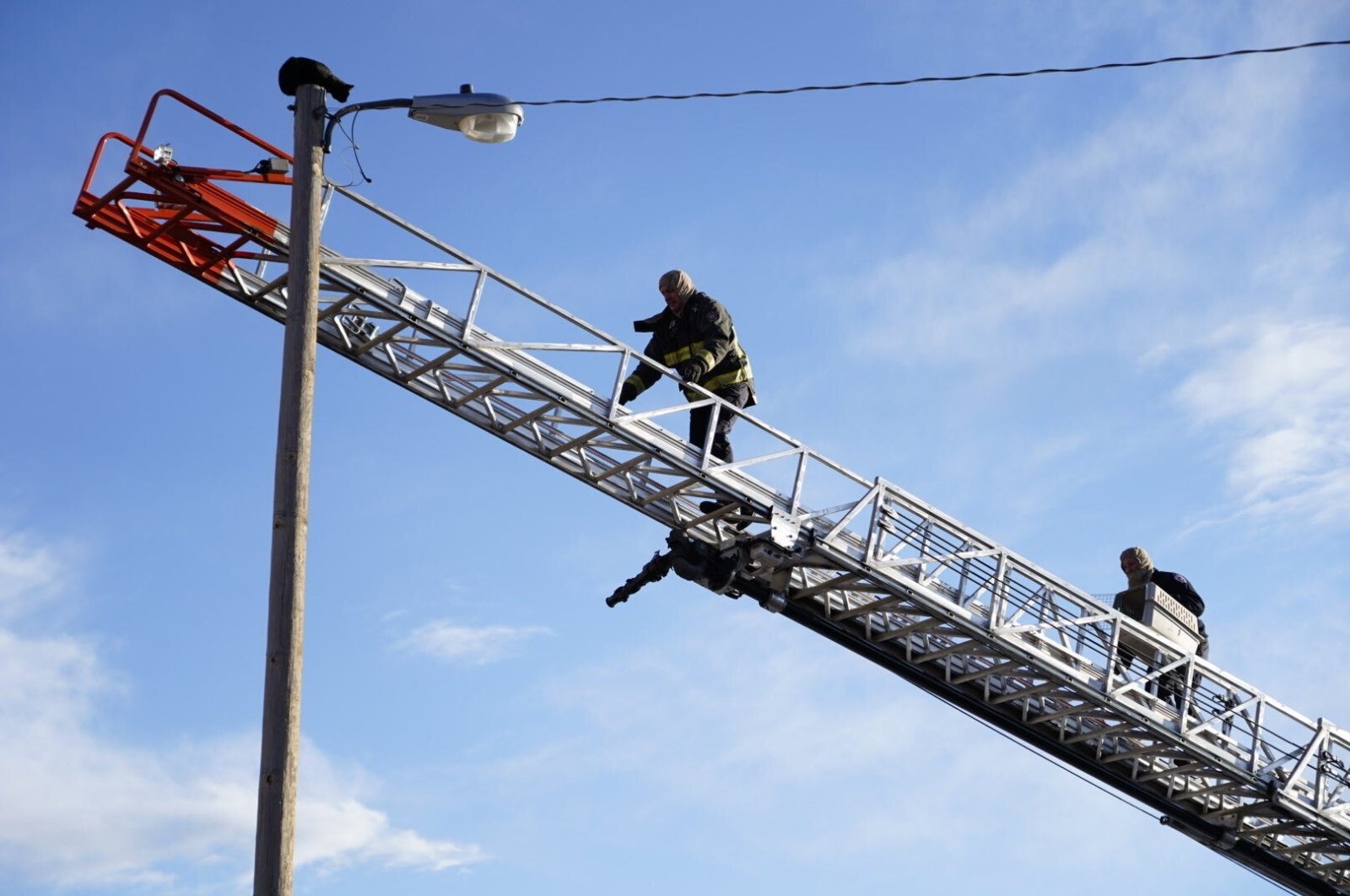 Aurora firefighters rescue Panther, a local cat who&#039;s been stuck on top of a 36-foot-high light pole for days, Aurora, Colorado, U.S., Dec. 10, 2021. (AP Photo)