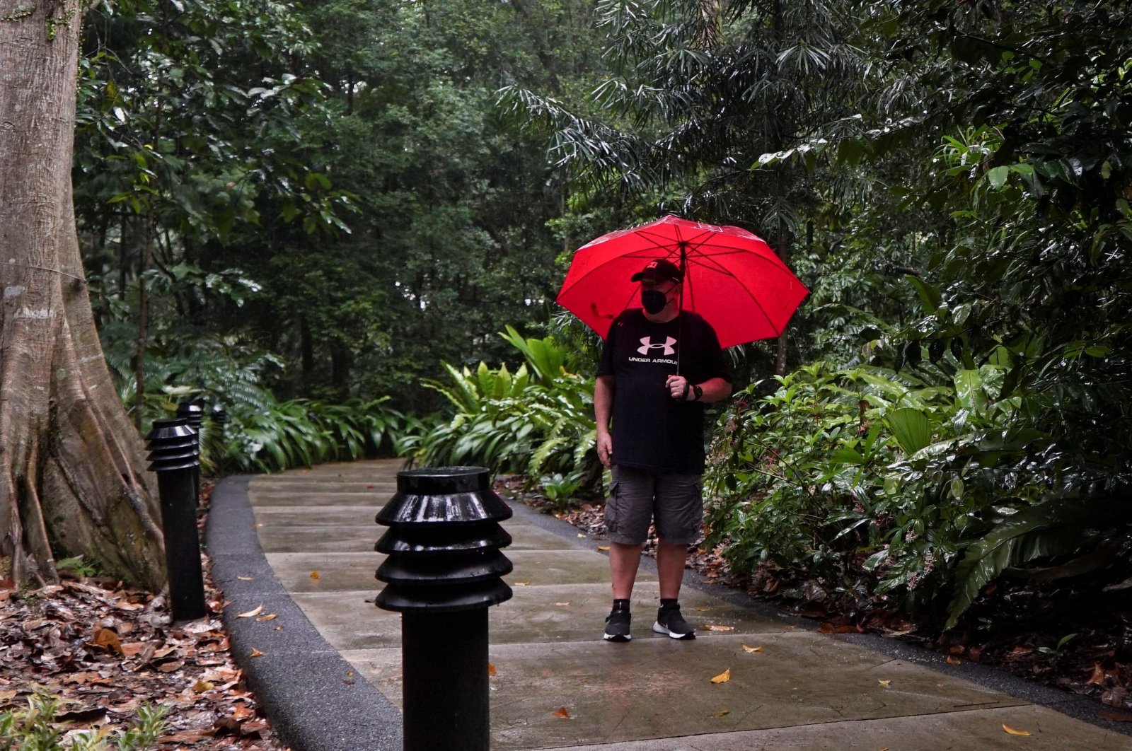 Singapore resident Graham George Spencer revisits the site where he was attacked by otters in late November, at the Singapore Botanical Gardens in Singapore, Dec. 11, 2021. (REUTERS)