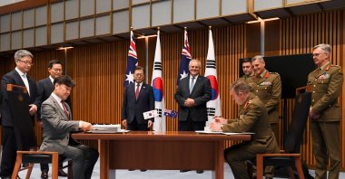 Australian Prime Minister Scott Morrison and South Korean President Moon Jae-in witness representatives of Hanwha Group and members of the Australian Defence Force during a signing ceremony at Parliament House, in Canberra, Australia, Dec. 13, 2021. (Reuters Photo)