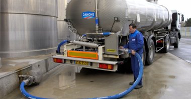 Milk tanker trucks in the unloading area at Danone dairy plant in Normandy, France. (Shutterstock Photo) 
