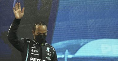 Mercedes driver Lewis Hamilton looks down as he walks onto the podium after finishing second in the F1 Abu Dhabi GP in Abu Dhabi, UAE, Dec. 12. 2021. (AP Photo)