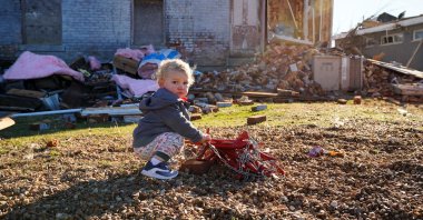 Gus Hart, 1, plays outside the home the Hart family had been renovating, with plans to move into, after a devastating outbreak of tornadoes ripped through several U.S. states in Mayfield, Kentucky, U.S., Dec. 12, 2021. (Reuters Photo)