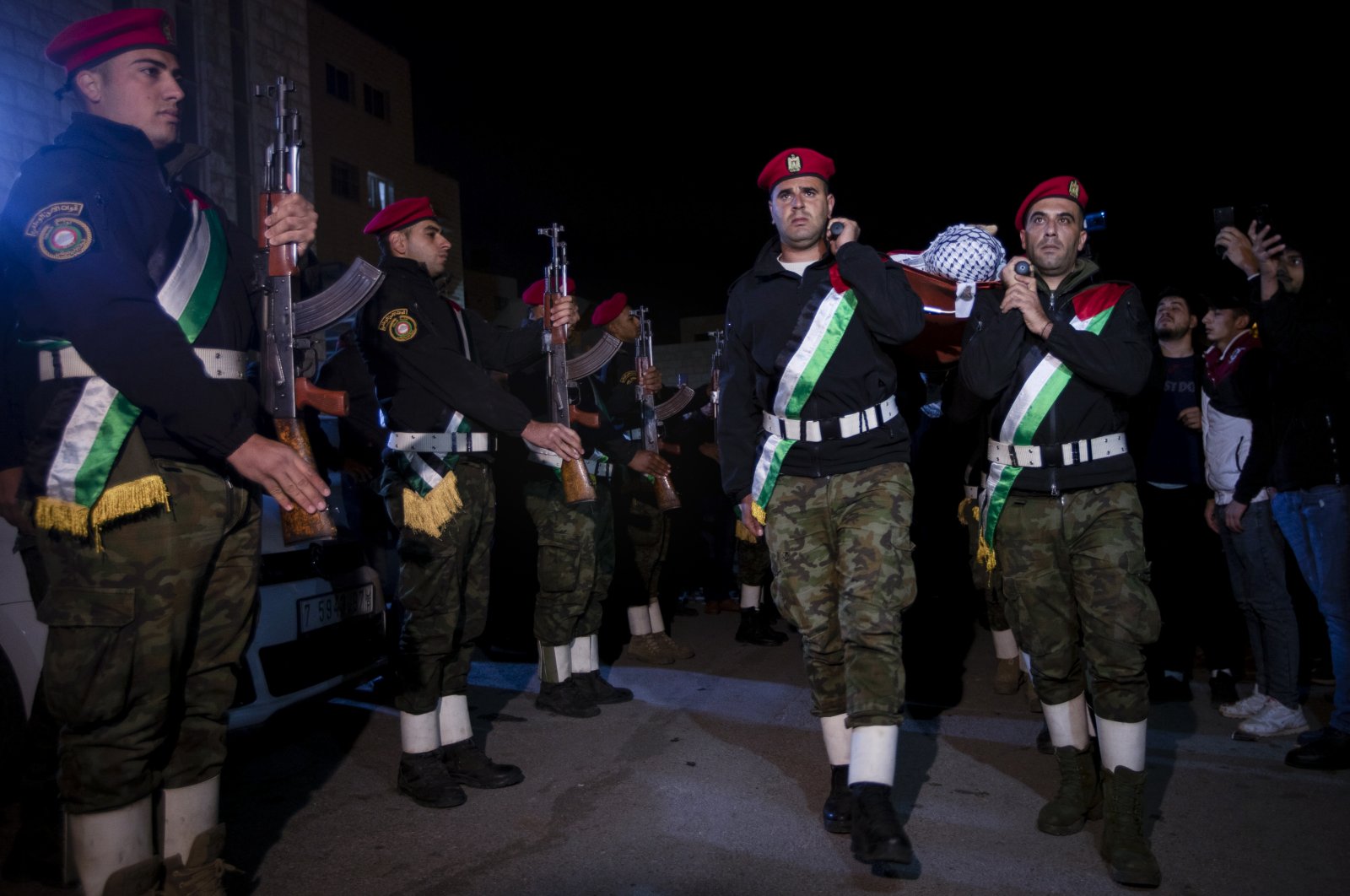 Members of the Palestinian national security forces carry the body of Jamil Abu Ayyash, 31, during his funeral in the West Bank city of Nablus, Palestine, Dec. 10, 2021. (AP Photo)